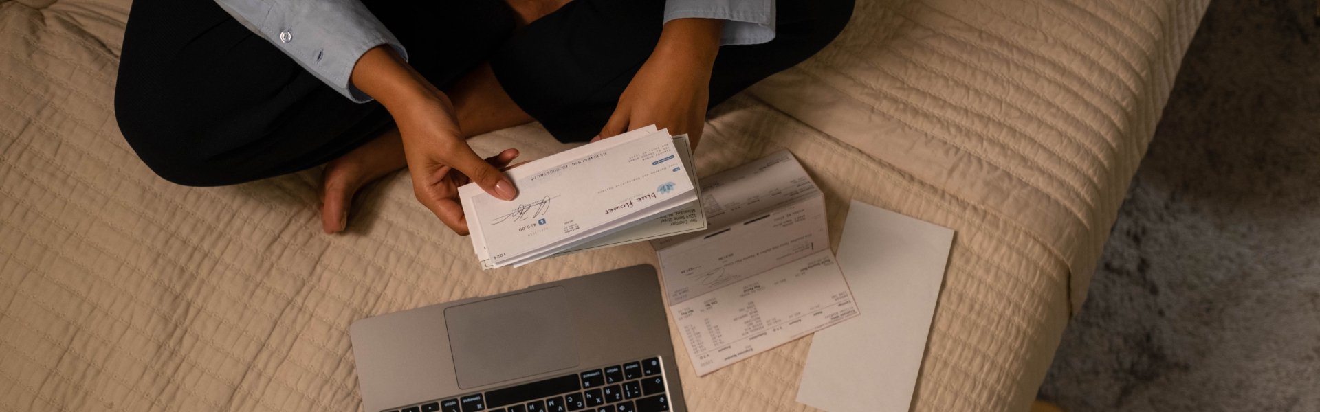 A person browsing her statement of account and checks